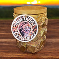 Handcrafted gold mosaic glass jar with handmade eucalyptus scented candle inside, showcasing intricate design and warm glow.