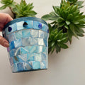 Turquoise mother of pearl flower pot with floral design, showcasing intricate shell inlay and decorative craftsmanship.