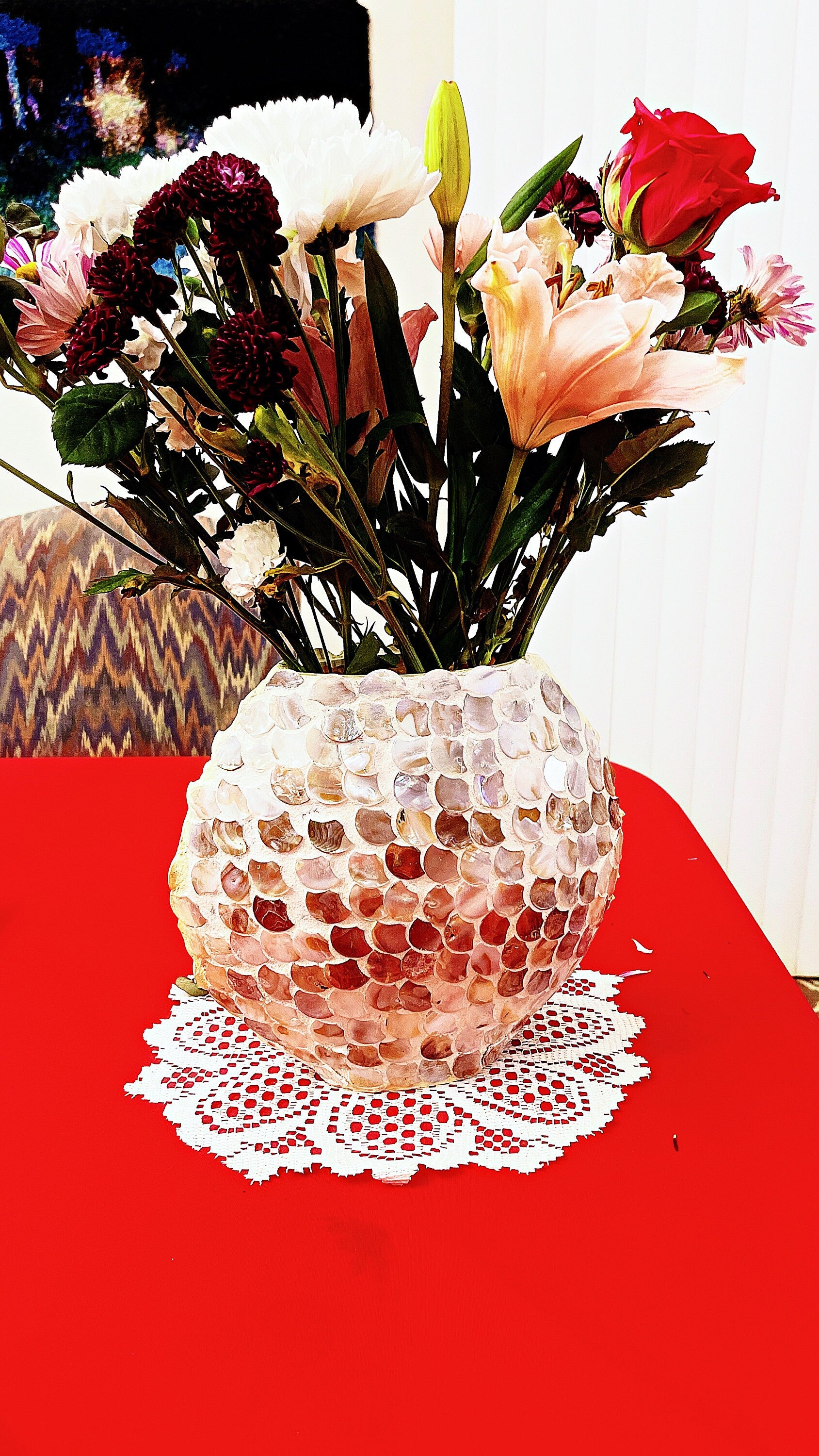 Handcrafted mother of pearl mosaic oval vase with intricate pattern, showcasing elegant craftsmanship and shimmering surface.
