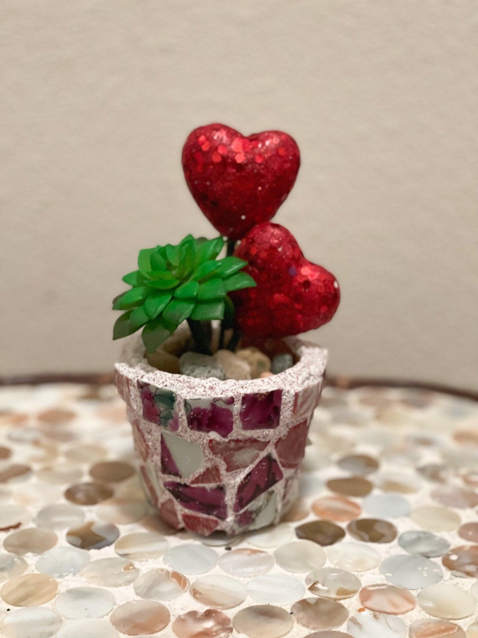 Handcrafted broken china heart mosaic planter with colorful tile patterns, perfect for decorative indoor or outdoor garden displays.