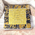 Gold and floral mosaic plant stand set with intricate patterns and vibrant colors, perfect for displaying potted plants.