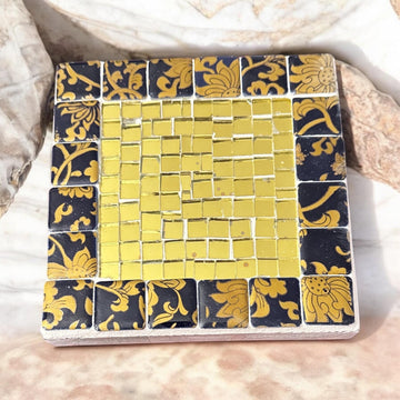 Gold and floral mosaic plant stand set with intricate patterns and vibrant colors, perfect for displaying potted plants.
