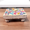 Square multicolored shell plant stand featuring vibrant shell patterns and sturdy structure for displaying potted plants.