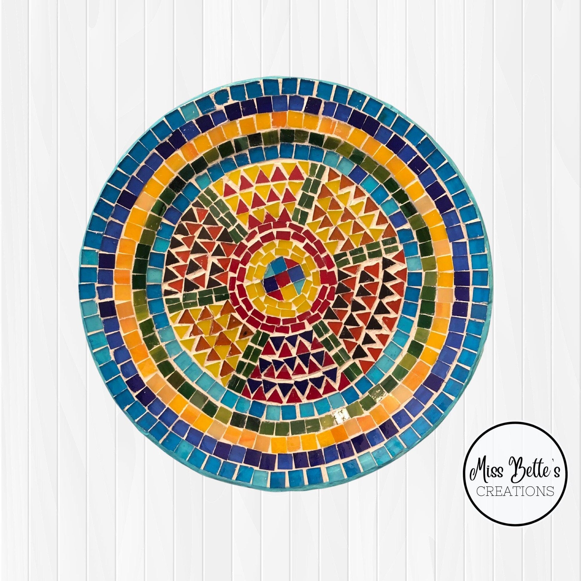 Handmade geometric mosaic plant plate with colorful tile patterns, ideal for decorative indoor or outdoor plant displays.