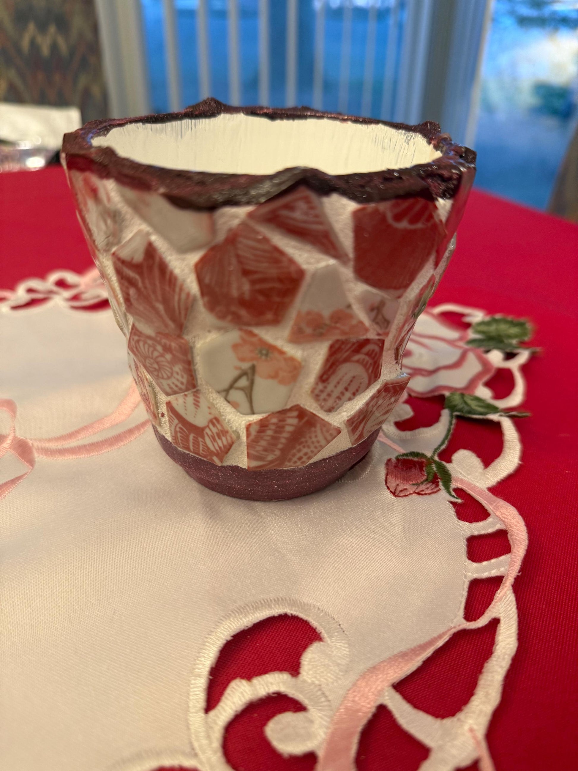 Handcrafted broken china mosaic flower pot with colorful floral design, showcasing intricate mosaic pattern and vibrant craftsmanship.