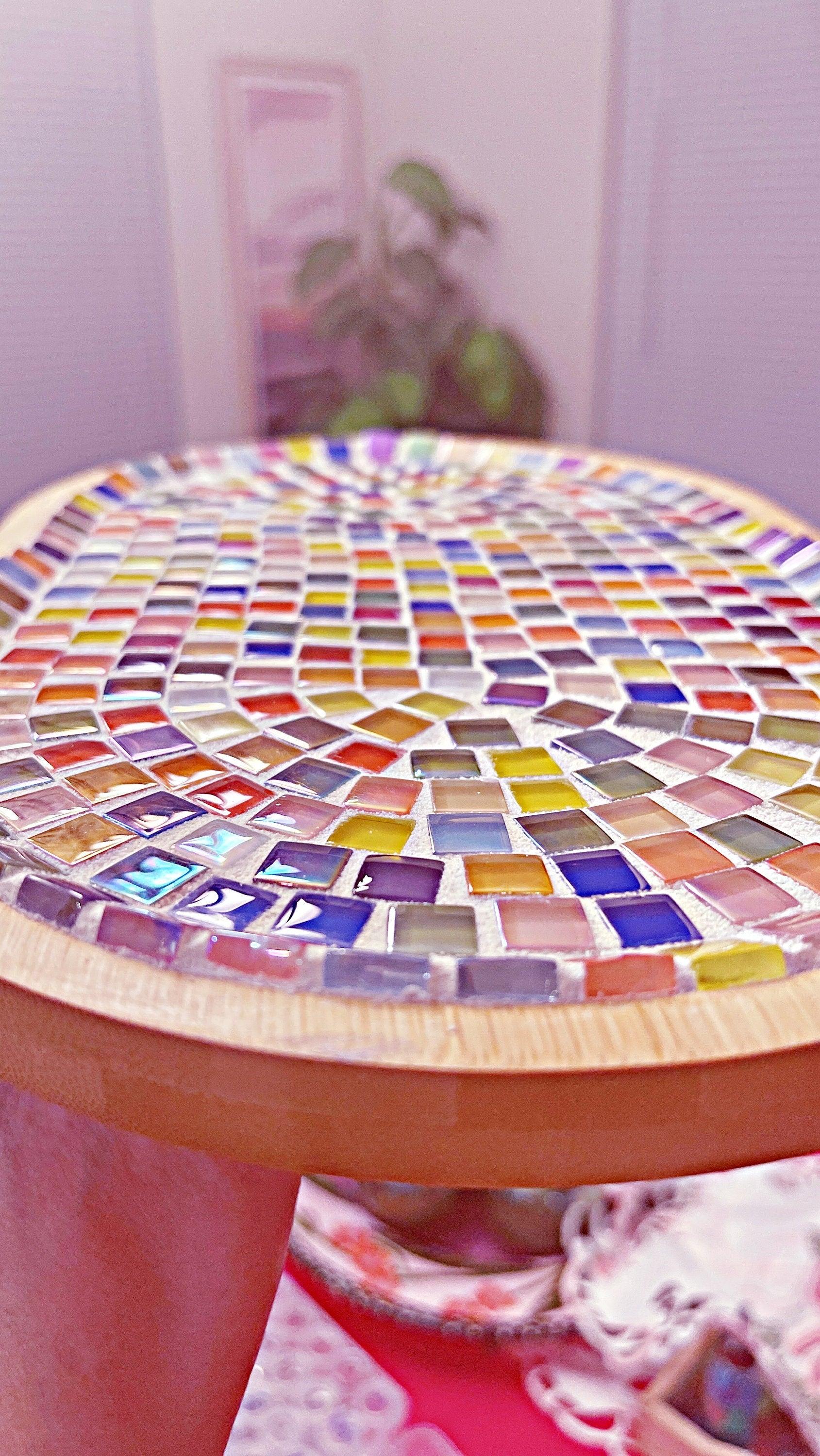 Handcrafted geometric star mosaic wall art featuring colorful ceramic tiles, ideal for modern home decor.