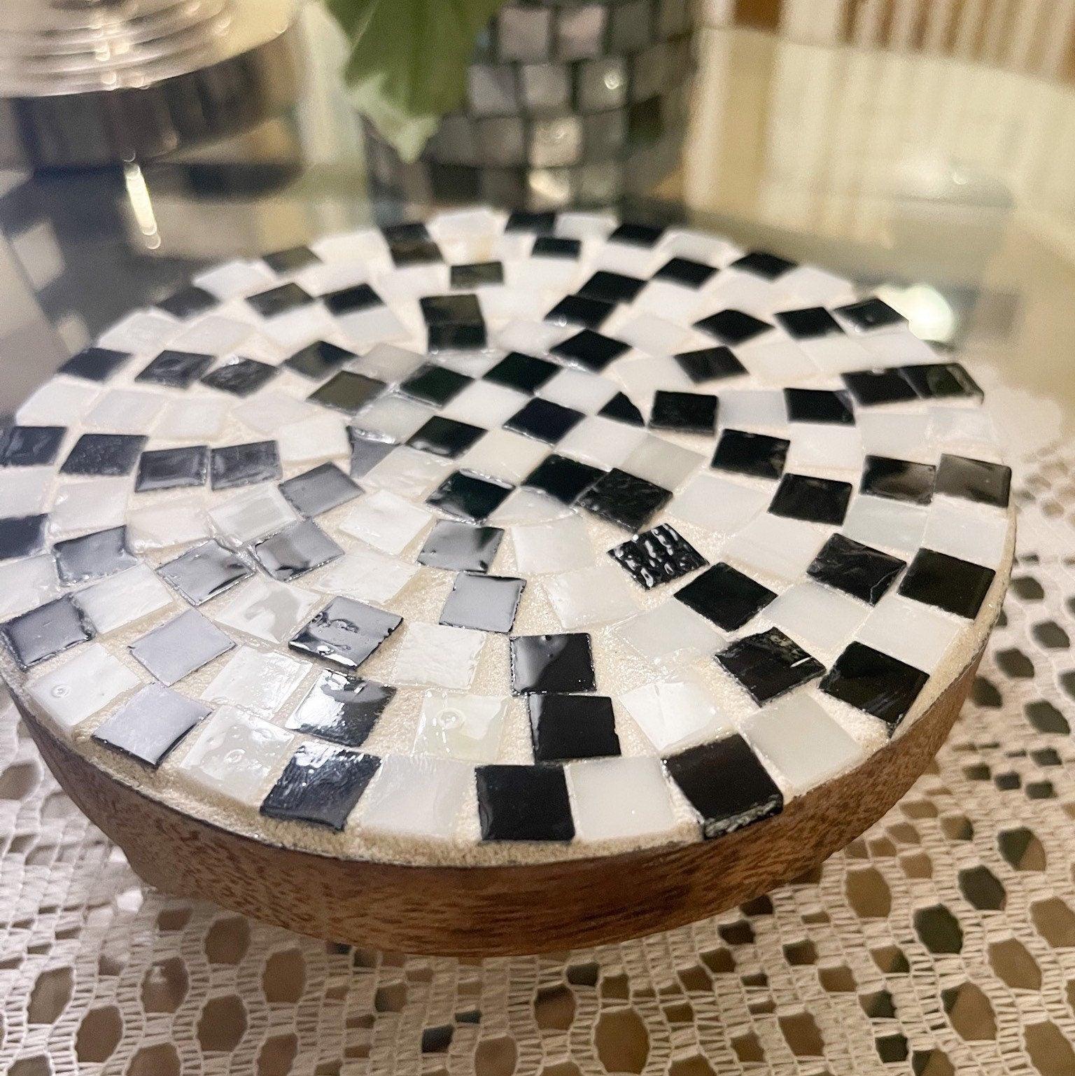 Black and white checkered mosaic plant stand with a sturdy base, designed for indoor or outdoor plants.