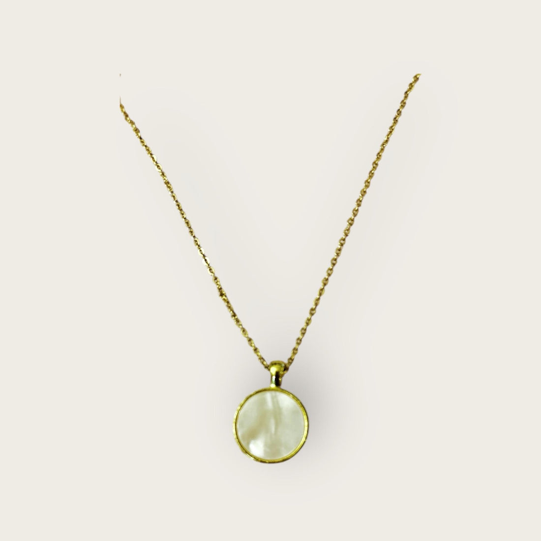 White mother of pearl round pendant necklace with silver chain, showcasing elegant jewelry design and smooth polished surface.