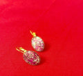 Pink iridescent glass crystal earrings with stainless steel gold posts, featuring a sparkling, colorful, and elegant design.