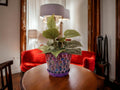 Purple and green mosaic flower pot with floral design, featuring vibrant patterns and a sturdy ceramic construction.