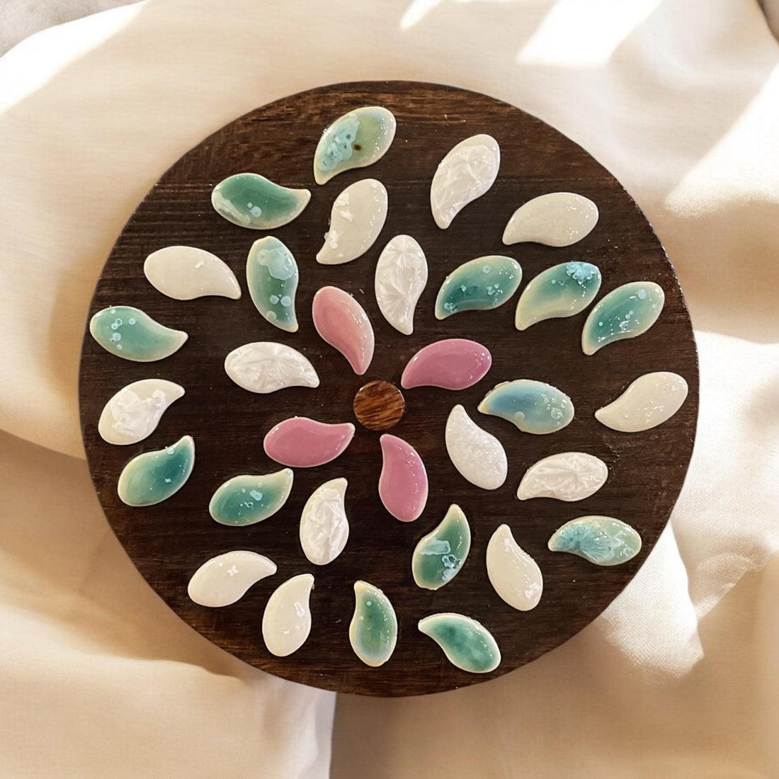 Handcrafted petal mosaic wooden plant stand with colorful floral design, perfect for indoor or outdoor plant displays.