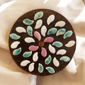 Handcrafted petal mosaic wooden plant stand with colorful floral design, perfect for indoor or outdoor plant displays.