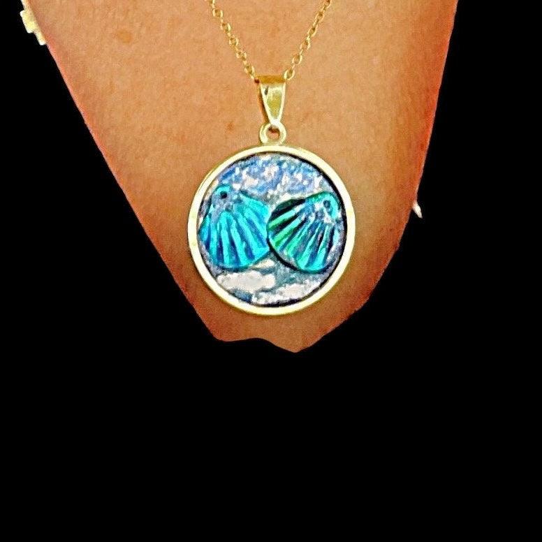 Ocean blue shell medallion necklace featuring a shell pendant on a delicate chain, stylish jewelry accessory.