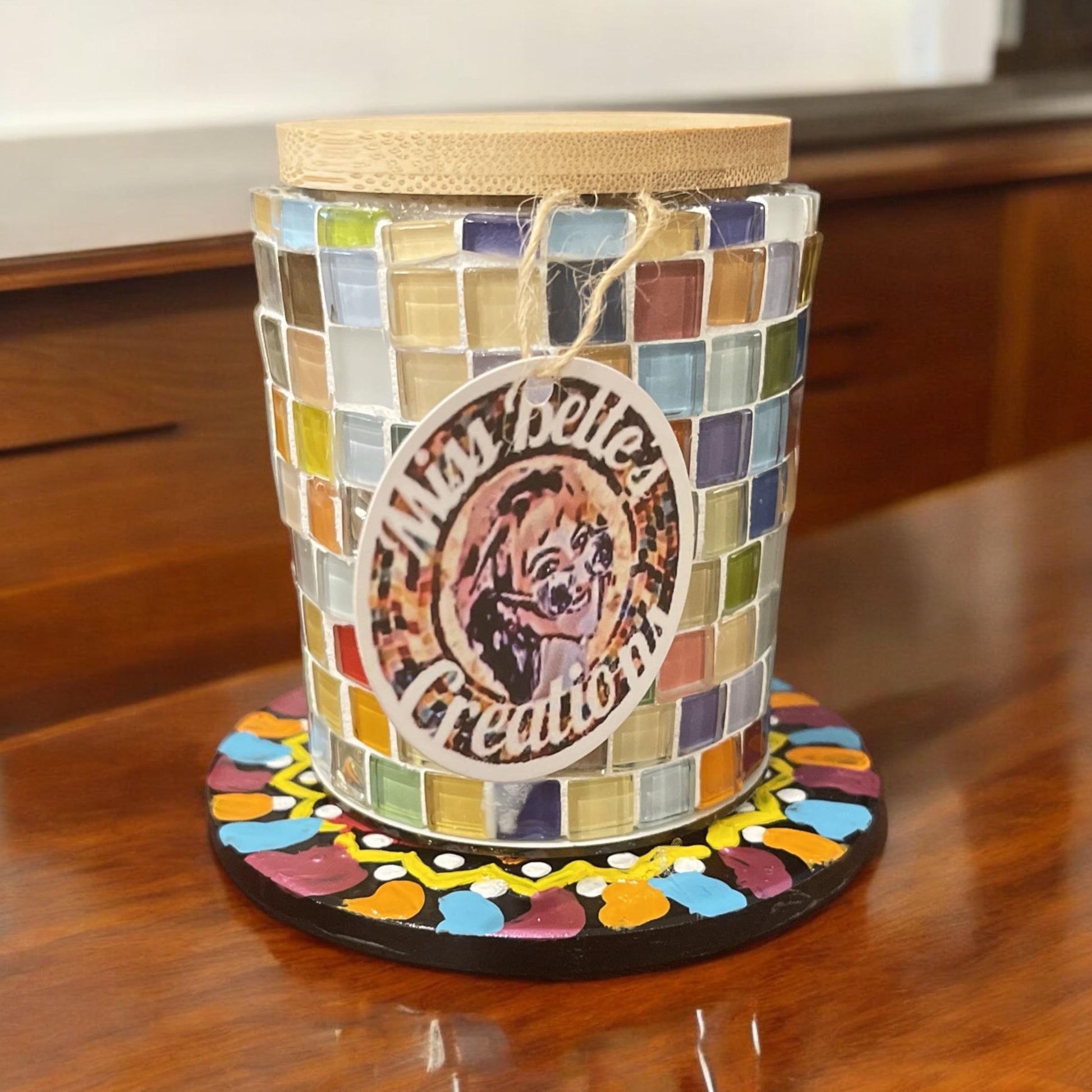 Artisan handcrafted mosaic glass jar with bamboo lid, decorative and colorful, perfect for home or display.