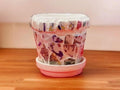 Handcrafted broken china mosaic planter with matching saucer, featuring colorful mosaic design for decorative indoor or outdoor use.