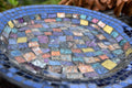 Iridescent blue glass mosaic wall art featuring shimmering blue tiles arranged in an abstract pattern for home decor.