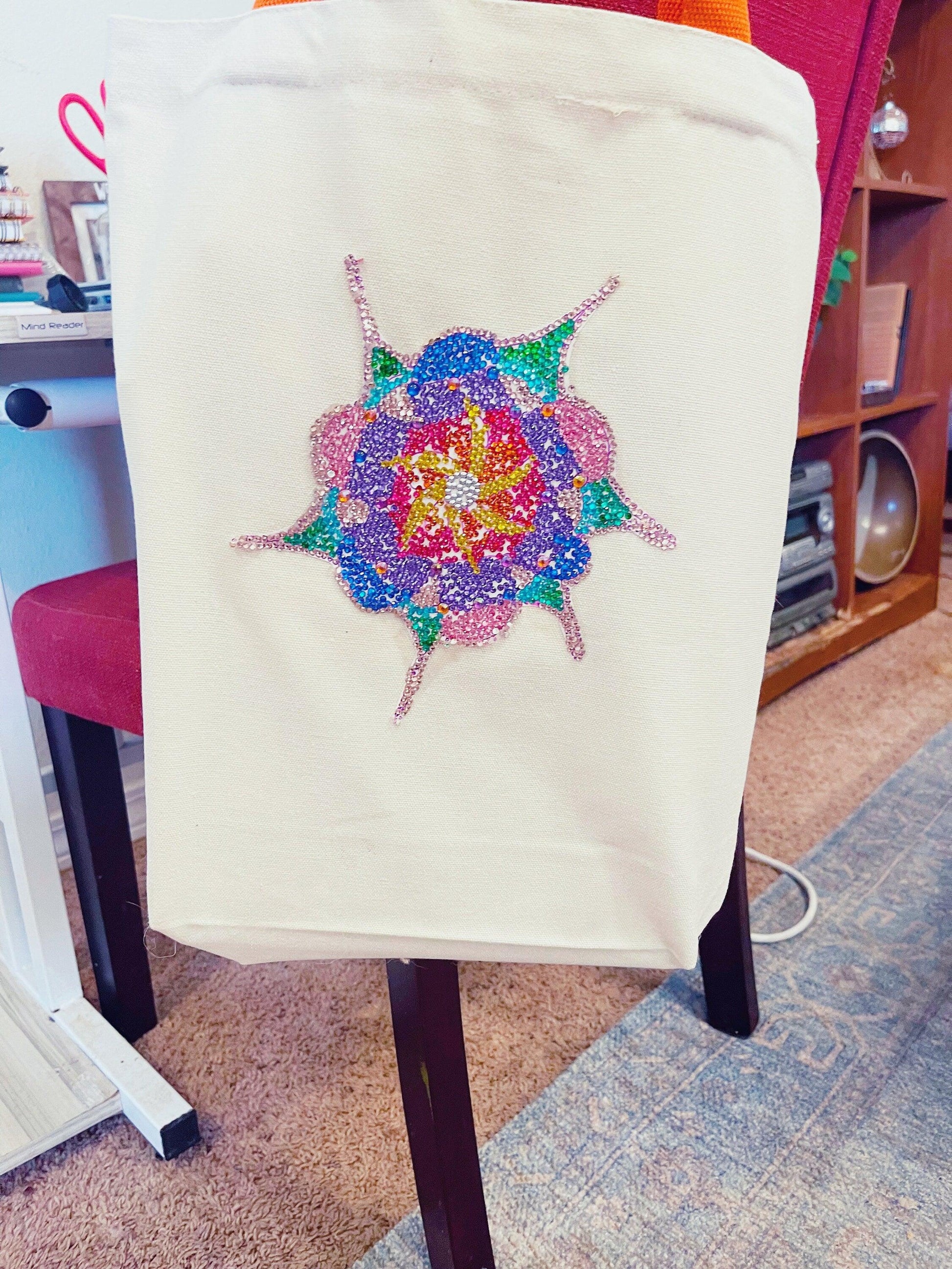 Handmade sparkling starburst diamond art canvas tote bag with colorful geometric design and sturdy handles.