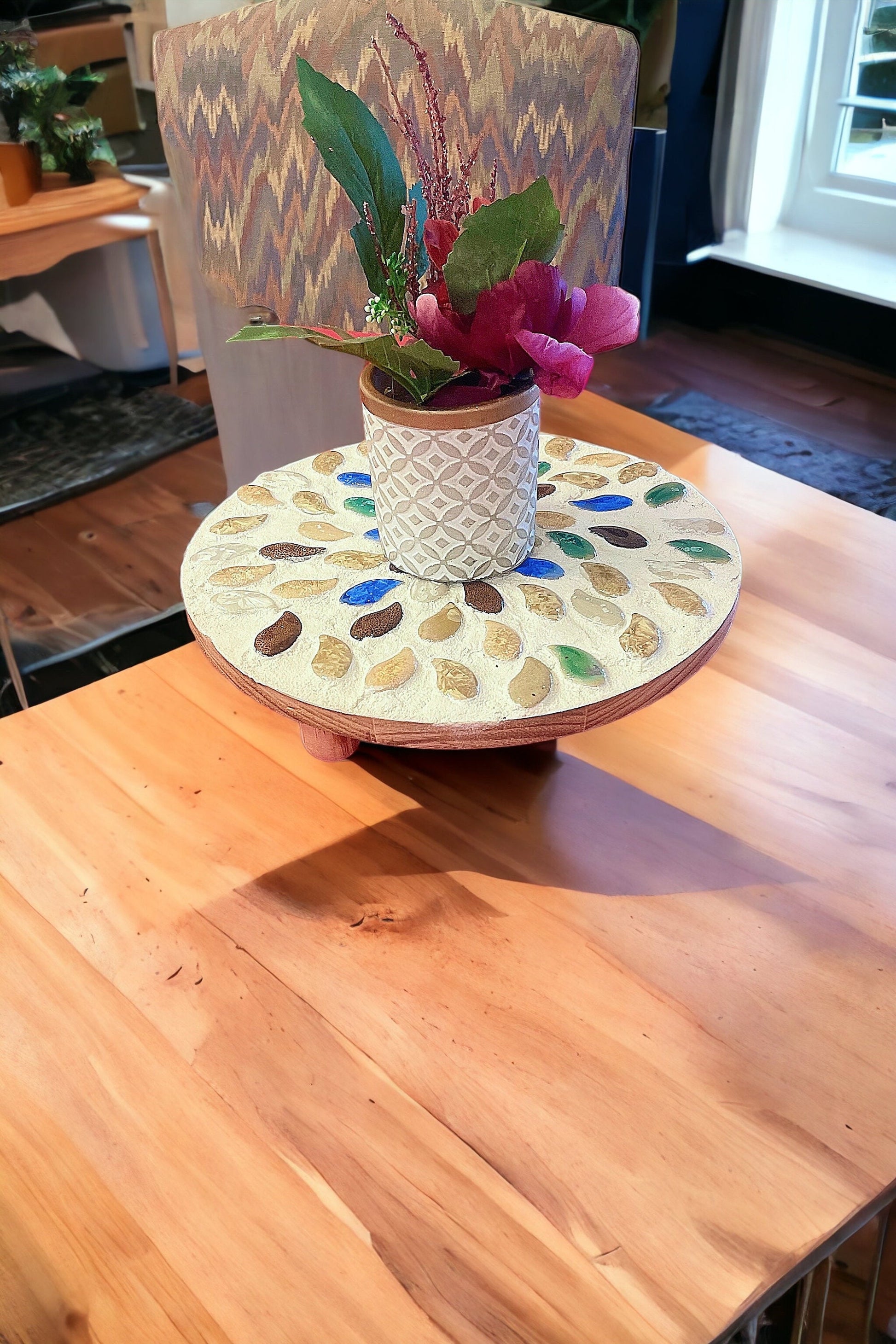 Handcrafted earth tone mosaic plant stand with three tiers, perfect for displaying potted plants in a stylish home or garden.