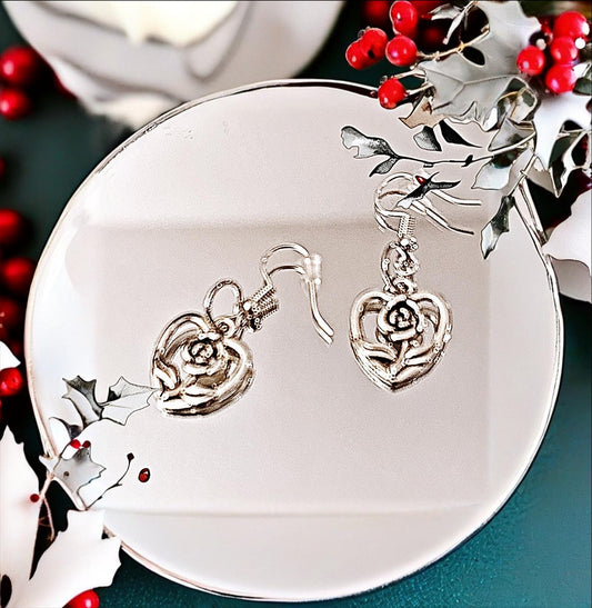 Triple layer heart dangle earrings with gold finish, featuring three connected heart charms hanging from delicate hooks.