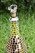 Luxury gold mosaic wine decanter with intricate design and elegant shape, perfect for serving fine wines.