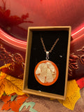 Artisan mosaic shell circle pendant featuring colorful shell pieces in a handcrafted jewelry design