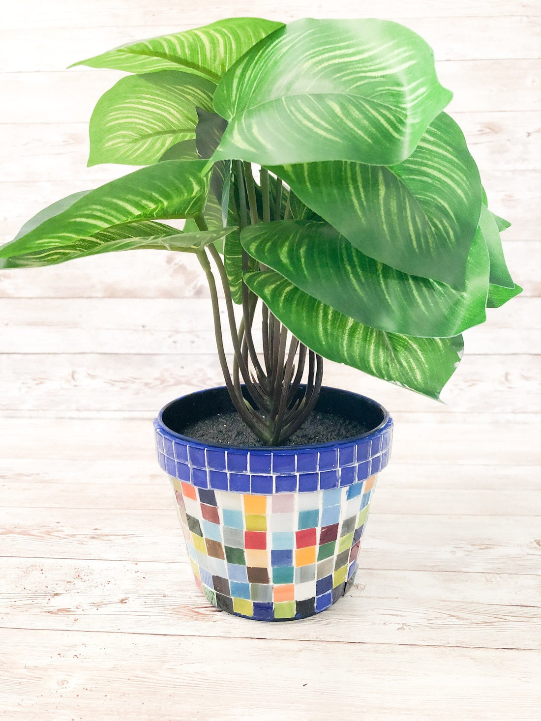 Colorful artisan rainbow mosaic planter with intricate tile design, perfect for outdoor or indoor plants.