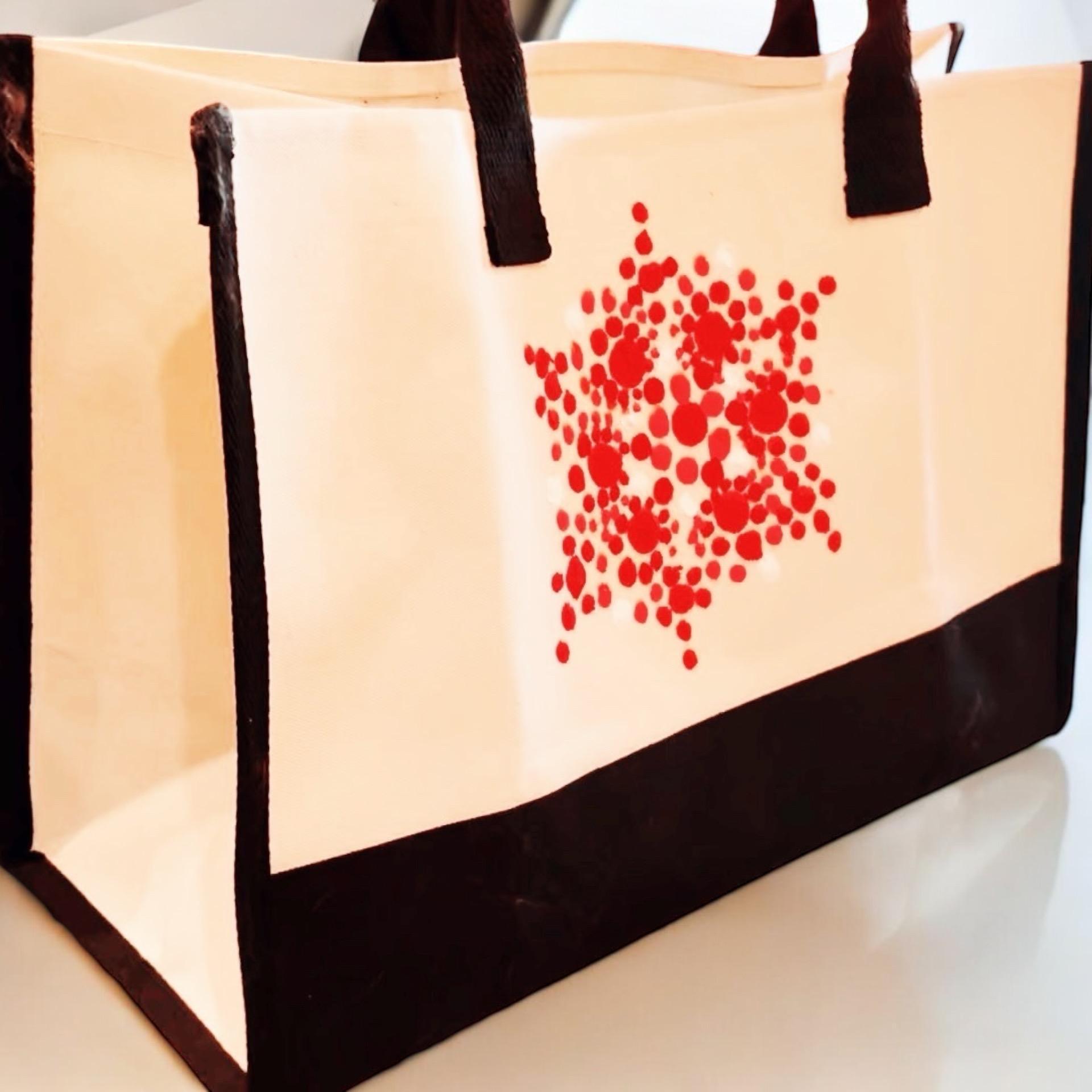 Large white and red custom canvas bag with sturdy handles, ideal for casual outings and personalized accessories.