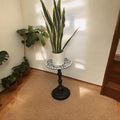 Handmade mosaic round side table with colorful tiled surface and wooden legs, perfect for living room decor.