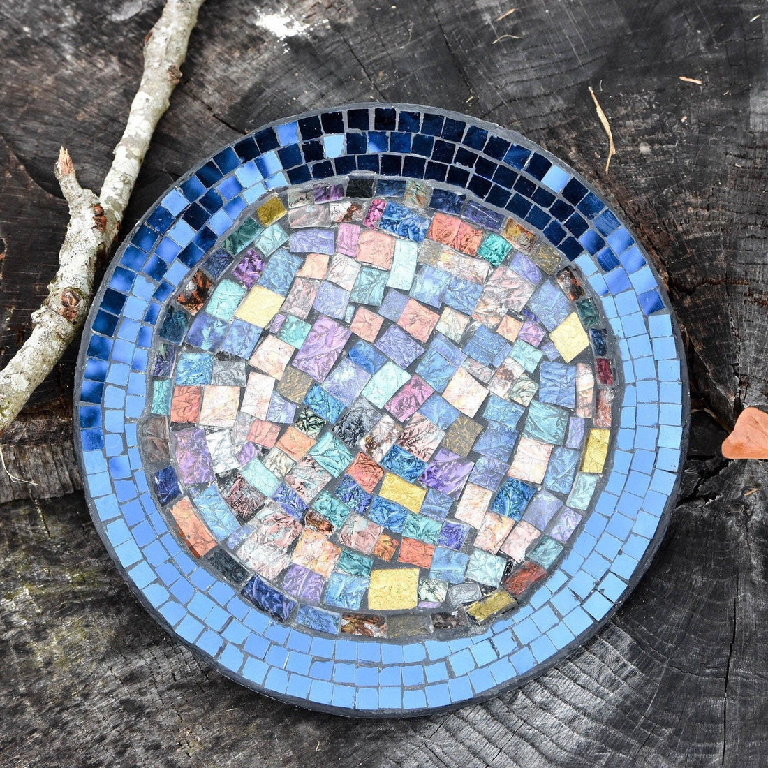 Iridescent blue glass mosaic wall art featuring shimmering geometric patterns, perfect for modern home decor.