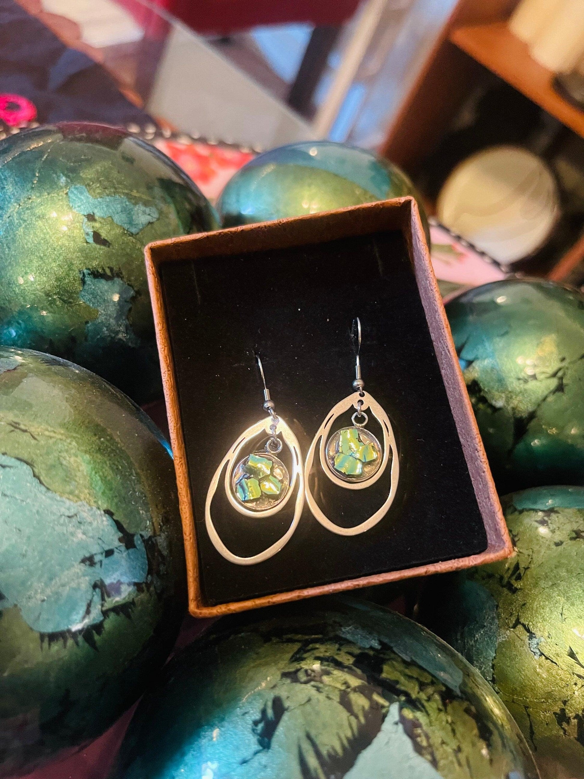 Double teardrop earrings with abalone shell featuring iridescent, natural shell patterns and silver hooks, by Descent.