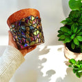 Iridescent mosaic planter with handcrafted design featuring colorful glass tiles, perfect for indoor or outdoor plants.