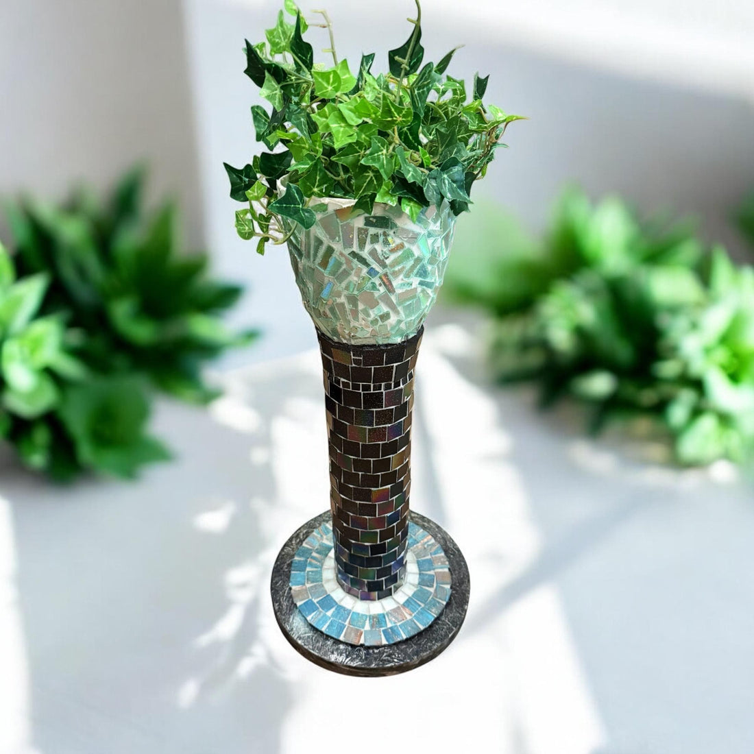 Colorful handcrafted mosaic pedestal planter with intricate tile patterns, perfect for indoor or outdoor decorative plant displays.