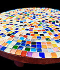 Handcrafted round rainbow mosaic plant stand with colorful tile design, perfect for showcasing potted plants in home decor.