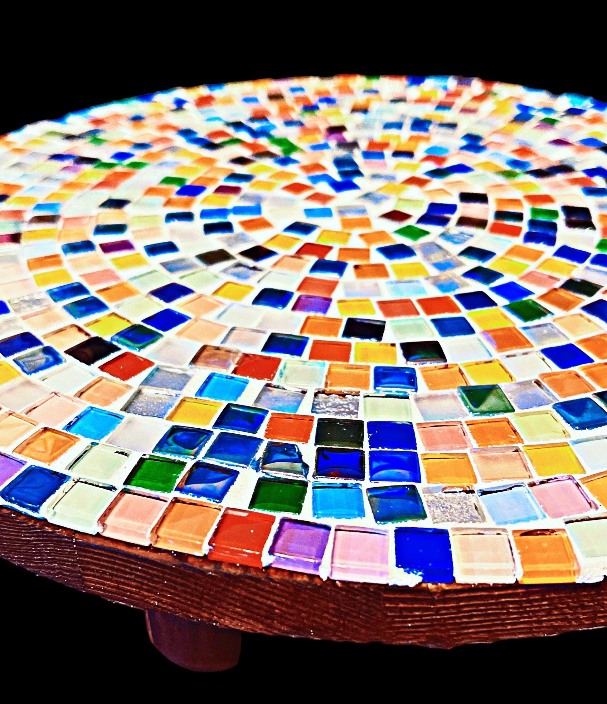 Handcrafted round rainbow mosaic plant stand with colorful tile design, perfect for showcasing potted plants in home decor.