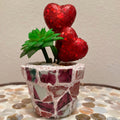 Handcrafted broken china heart mosaic planter with colorful mosaic design, perfect for indoor or outdoor decorative plants.