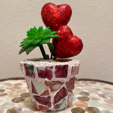 Handcrafted broken china heart mosaic planter with colorful mosaic design, perfect for indoor or outdoor decorative plants.