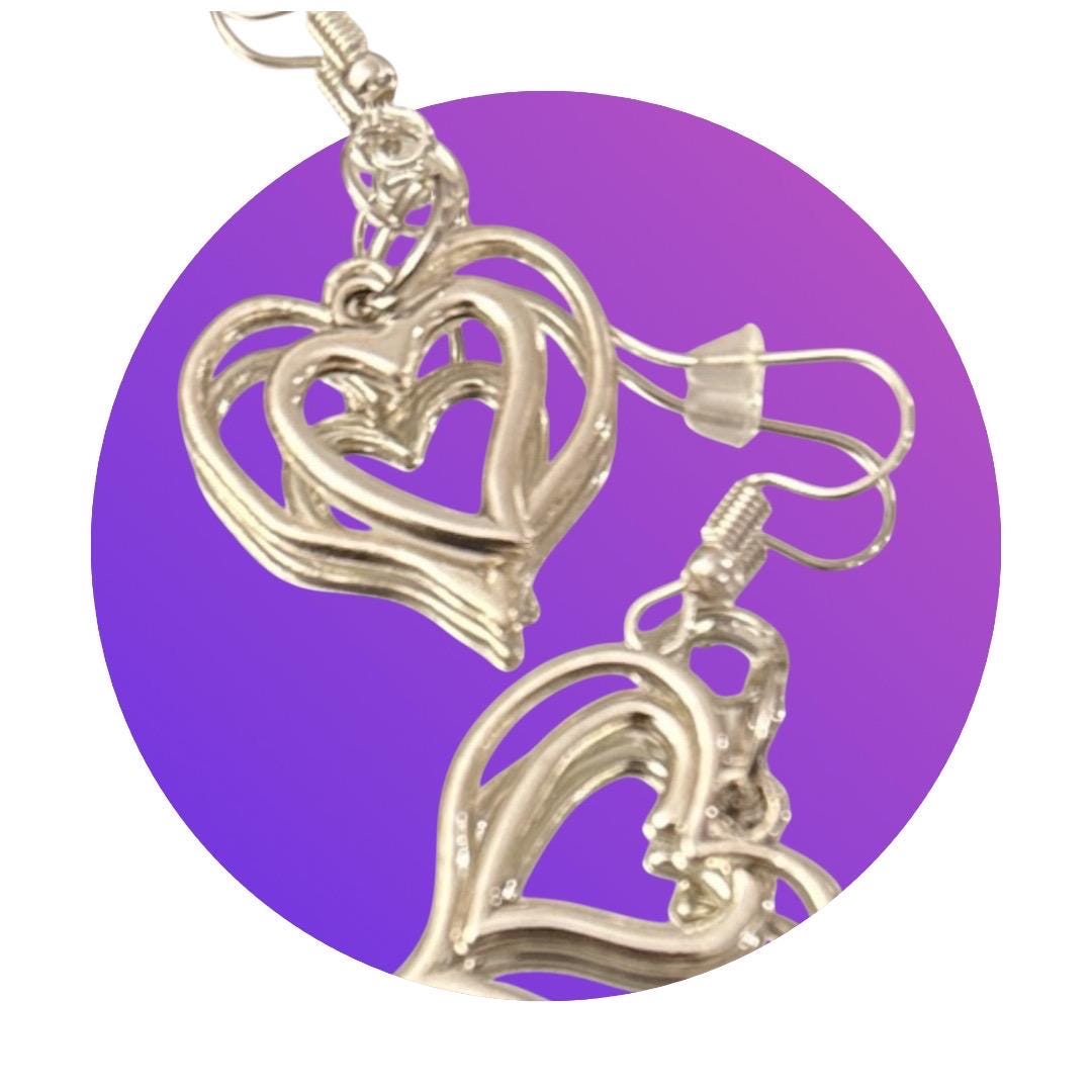 Silver triple layer heart dangle earrings with intricate design, stylish jewelry accessory for women.