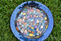 Iridescent blue glass mosaic wall art featuring shimmering geometric patterns, perfect for modern home decor.