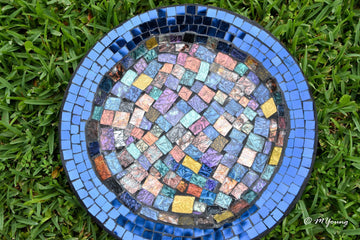 Iridescent blue glass mosaic wall art featuring shimmering geometric patterns, perfect for modern home decor.