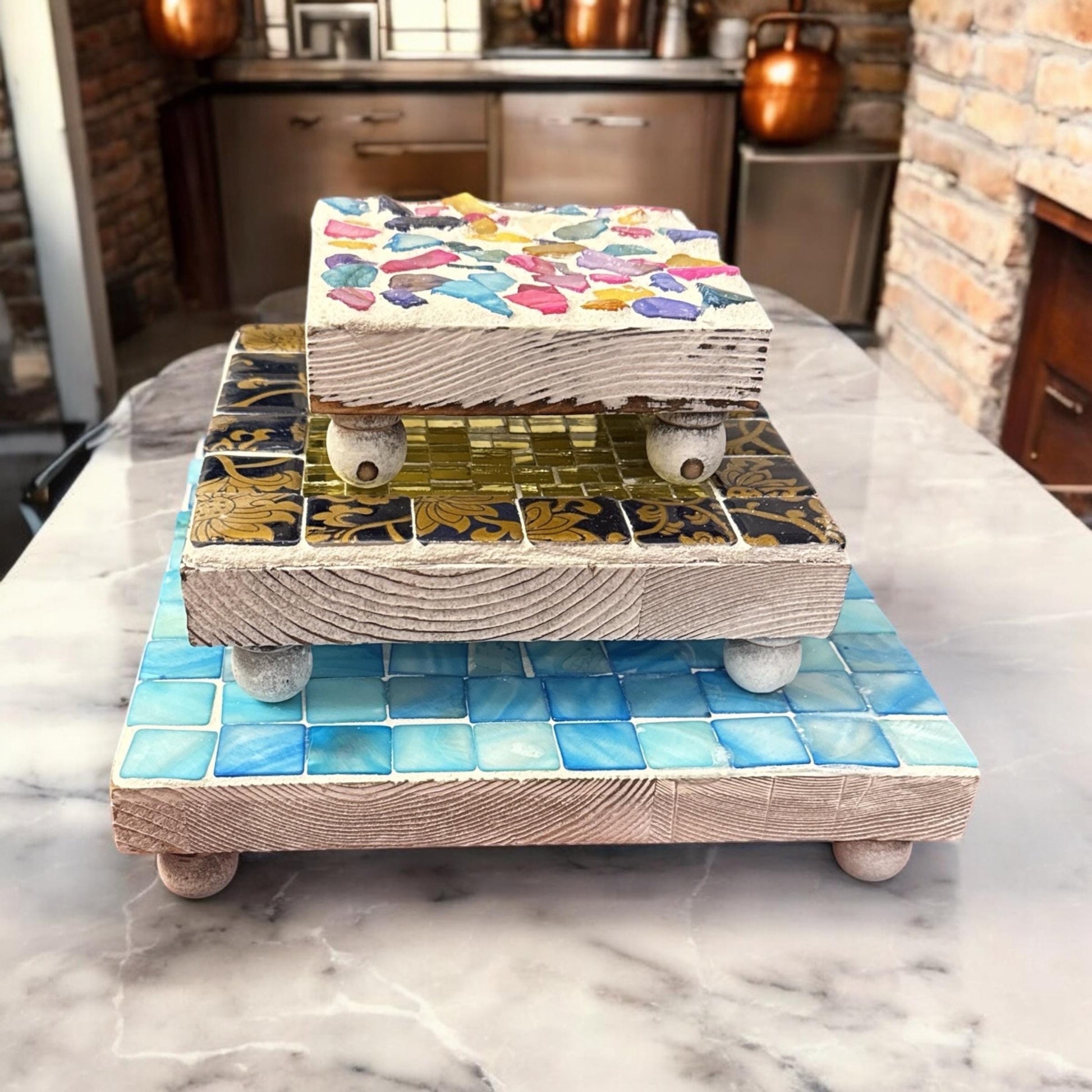 Miss Bette's Creations gold and floral mosaic plant stand set with four decorative stands for indoor plants.