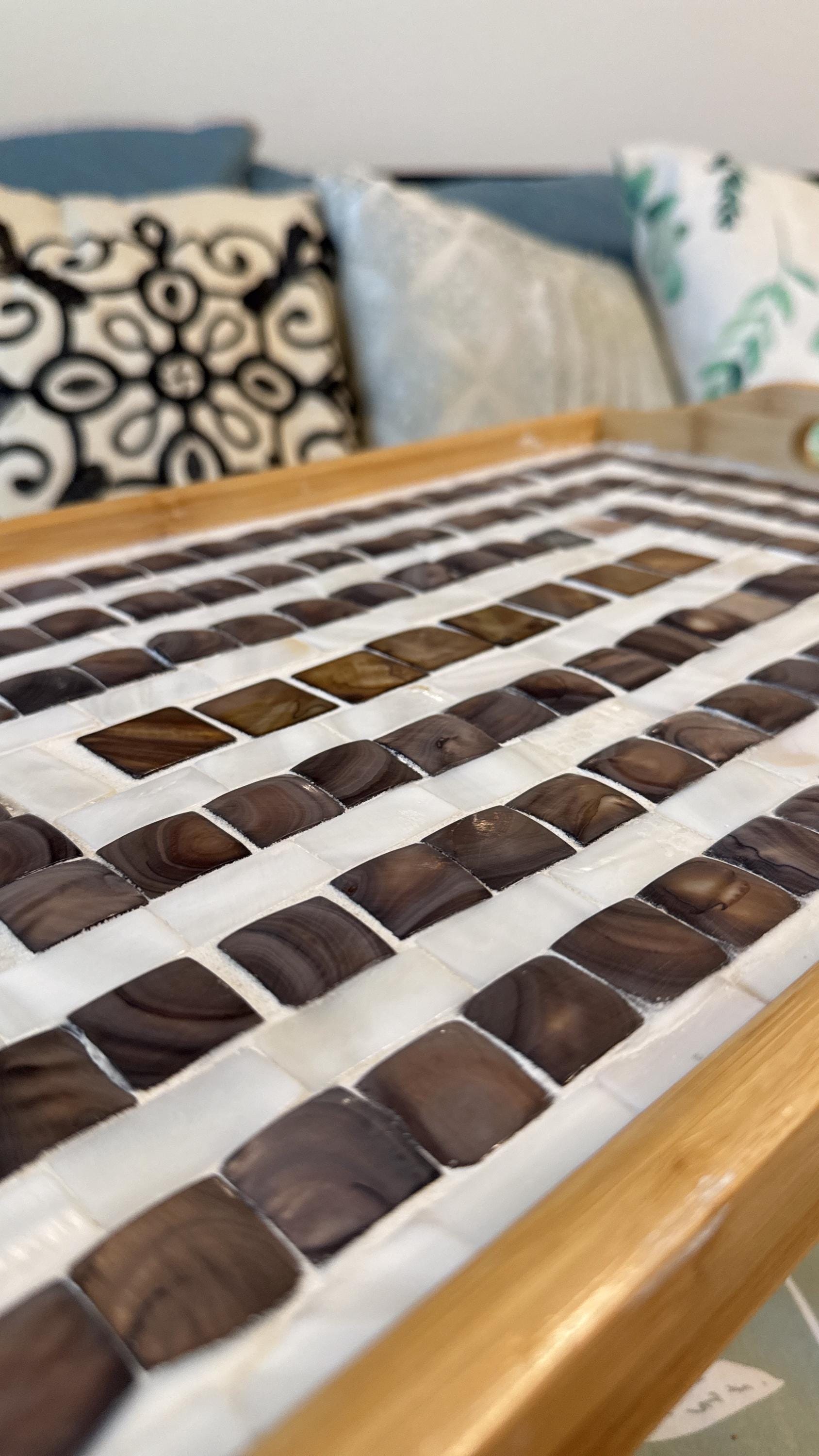 Rustic bamboo bed tray with stone mosaic inlay, featuring handles for serving and a natural finish for a stylish, functional piece.