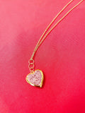 Gold sparkling rose-shaped heart locket with intricate details, ideal for jewelry lovers seeking elegant accessories.