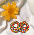 Multicolored crystal on wood hoop earrings with gold-tone accents, stylish and vibrant jewelry accessory.