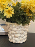 Handcrafted seashell mosaic plant pot with colorful shell patterns, ideal for indoor or outdoor decorative gardening.
