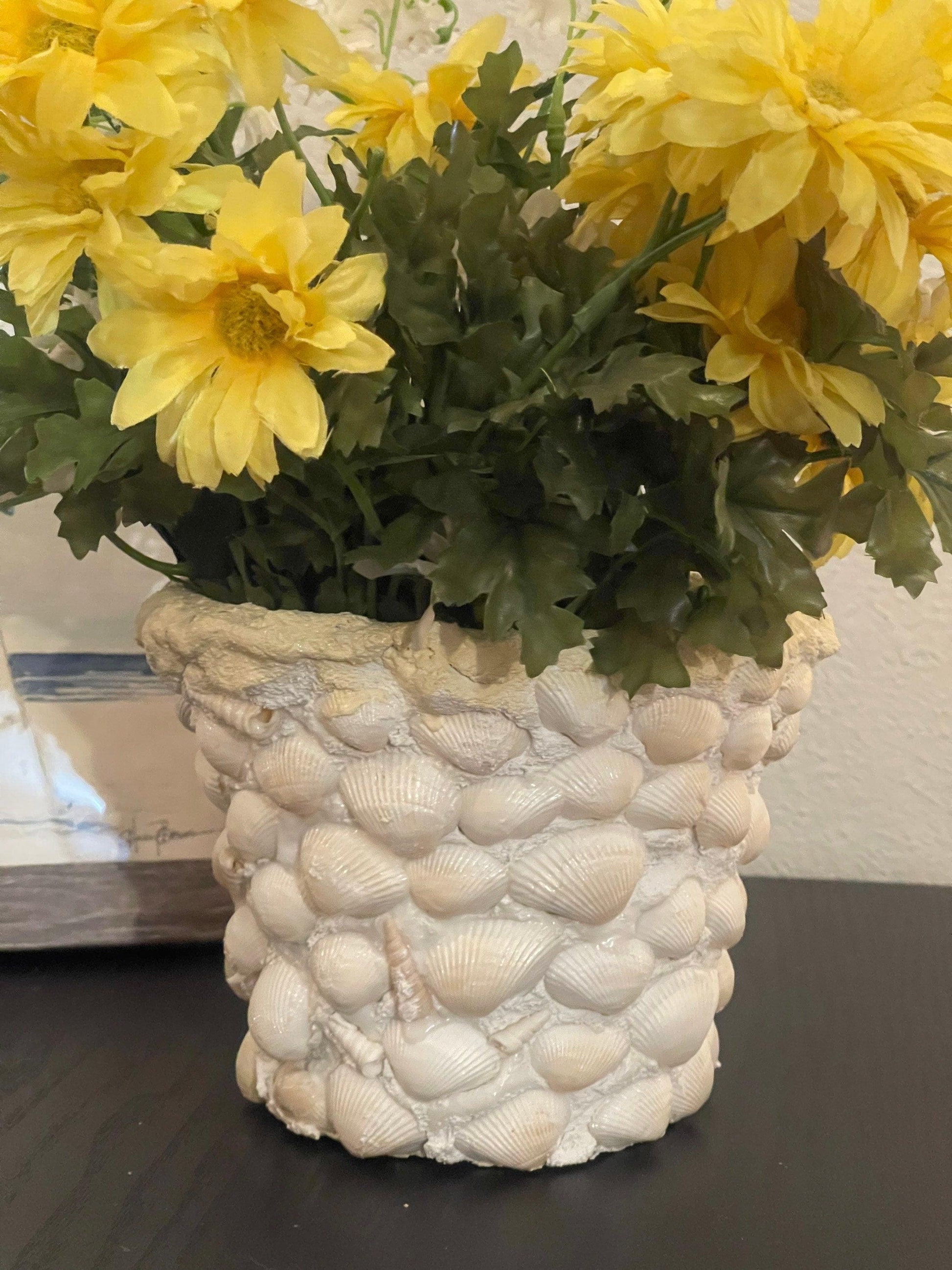 Handcrafted seashell mosaic plant pot with colorful shell patterns, ideal for indoor or outdoor decorative gardening.