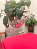 Hanging disco ball planter from Miss Bette's Creations with artificial pink carnations, shiny reflective surface, and decorative design.