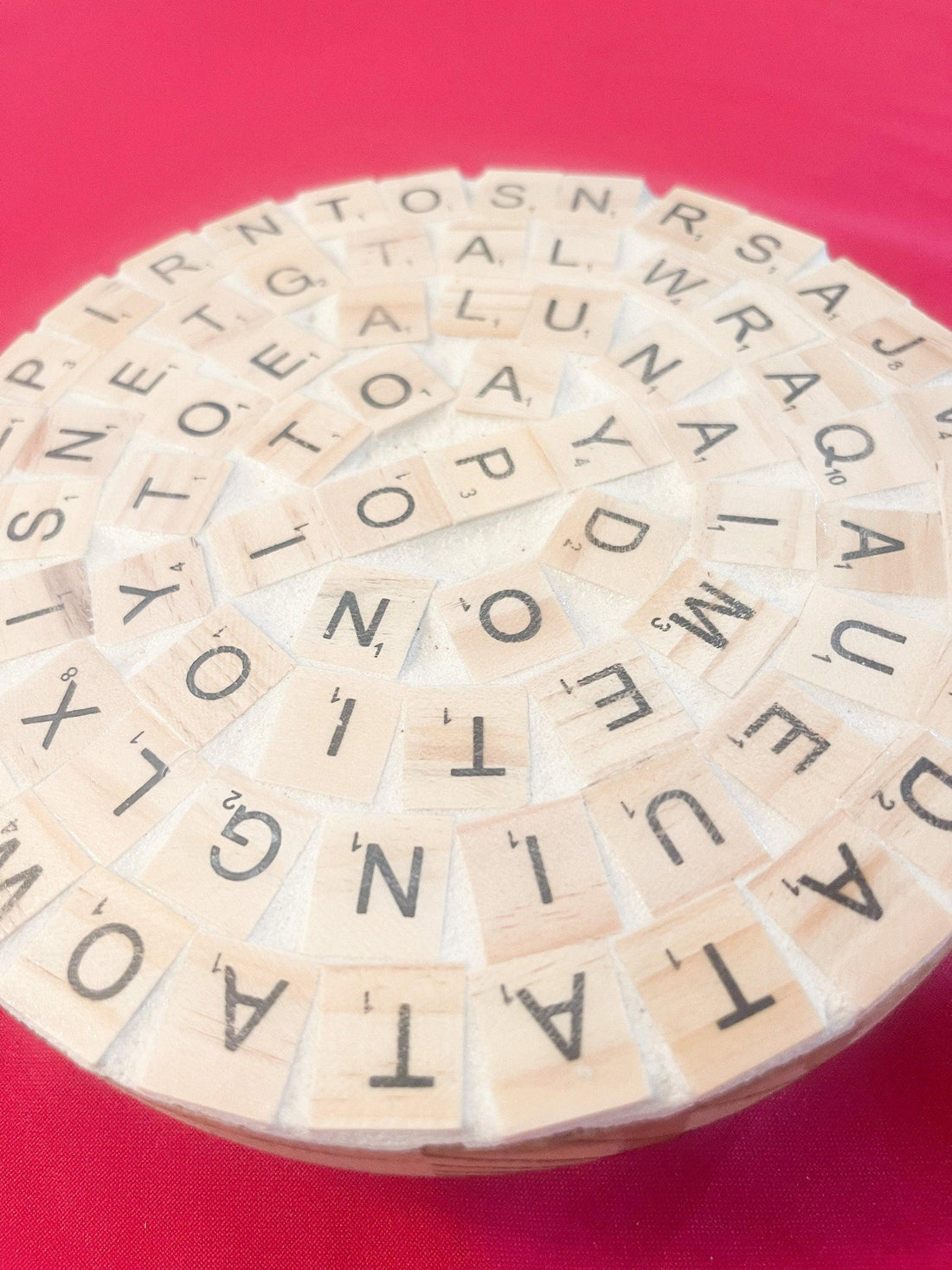 Decorative word game-themed plant stand with wooden letters and greenery, perfect for modern home plant decor.