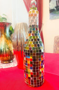 Stained glass look wine decanter with intricate colorful glass design, elegant shape for serving wine.