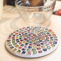 Handcrafted blue and amber mosaic plant stand with intricate tile design, ideal for displaying indoor or outdoor plants.