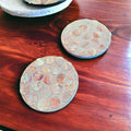 Mother of Pearl mosaic coaster set featuring four elegant coasters with iridescent pearl patterns, perfect for protecting surfaces.